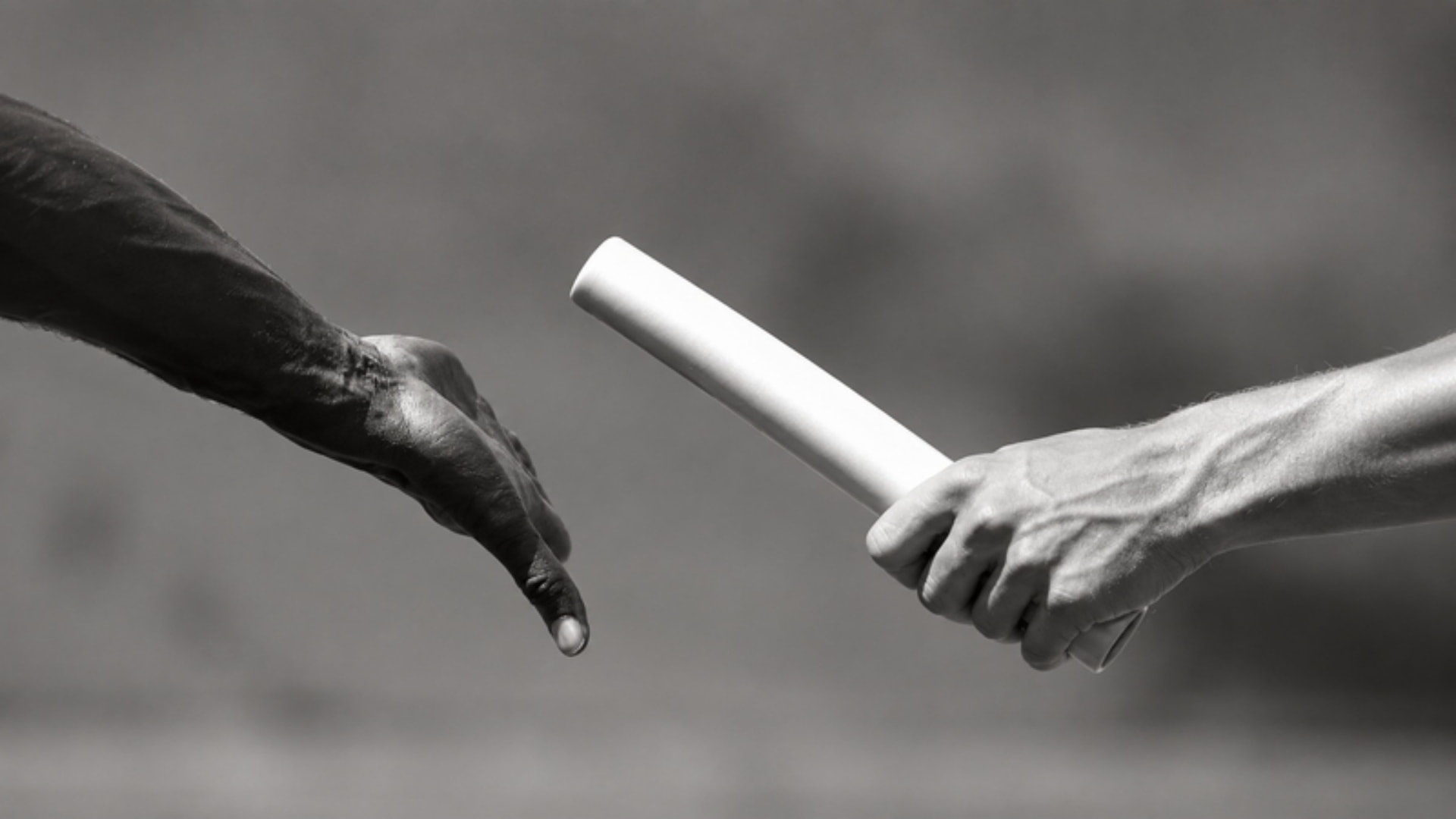 Hands passing a relay baton